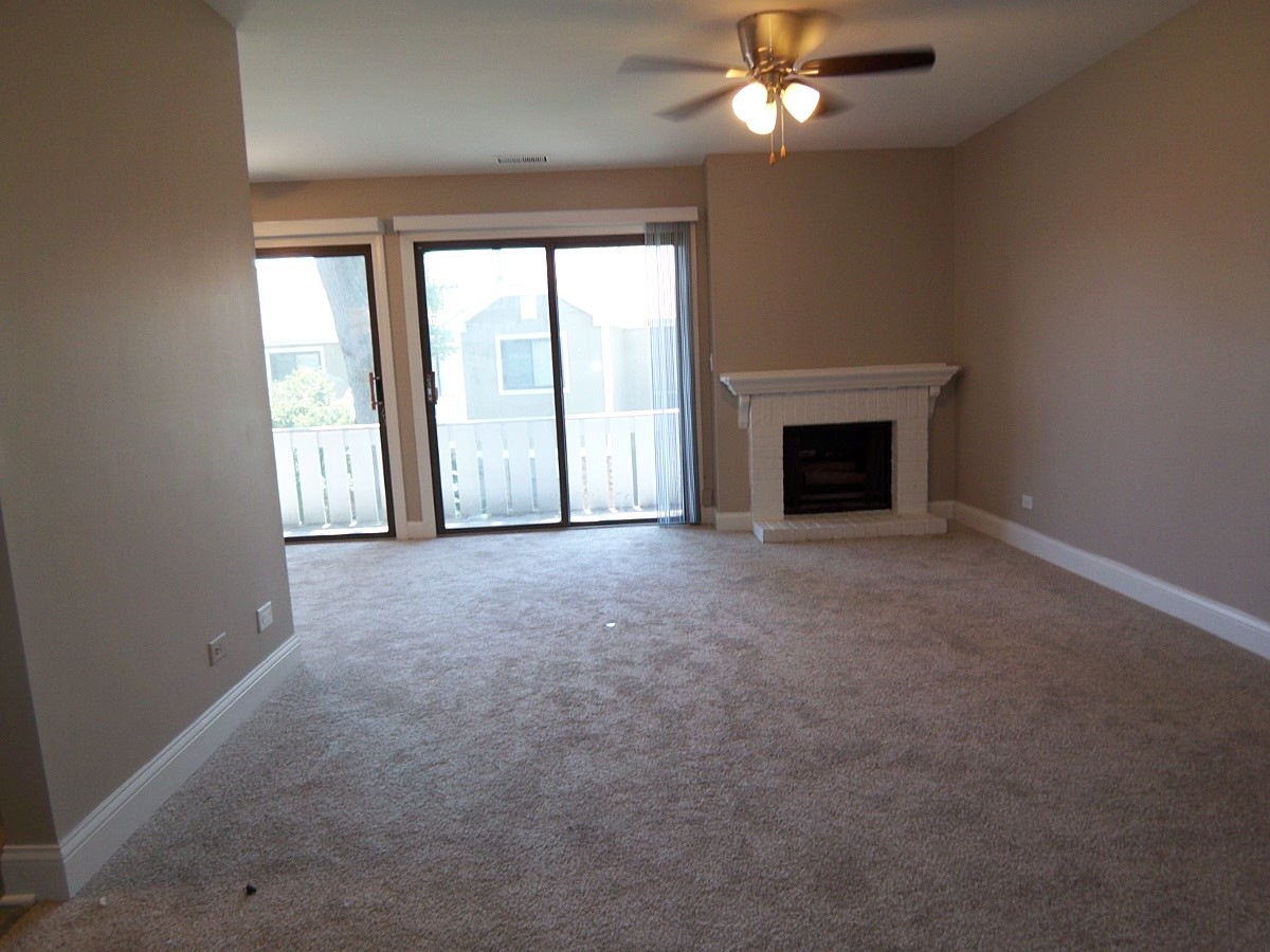 1517 7 Pines Road, Unit C2 Schaumburg, IL 60193 - Photo 6 of 34 an empty room with chandelier fan and windows