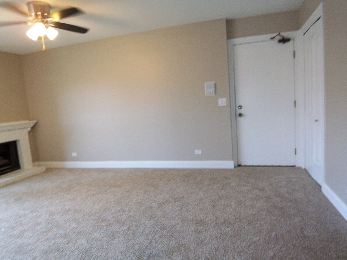 1517 7 Pines Road, Unit C2 Schaumburg, IL 60193 - Photo 7 of 34 a view of an empty room and chandelier fan