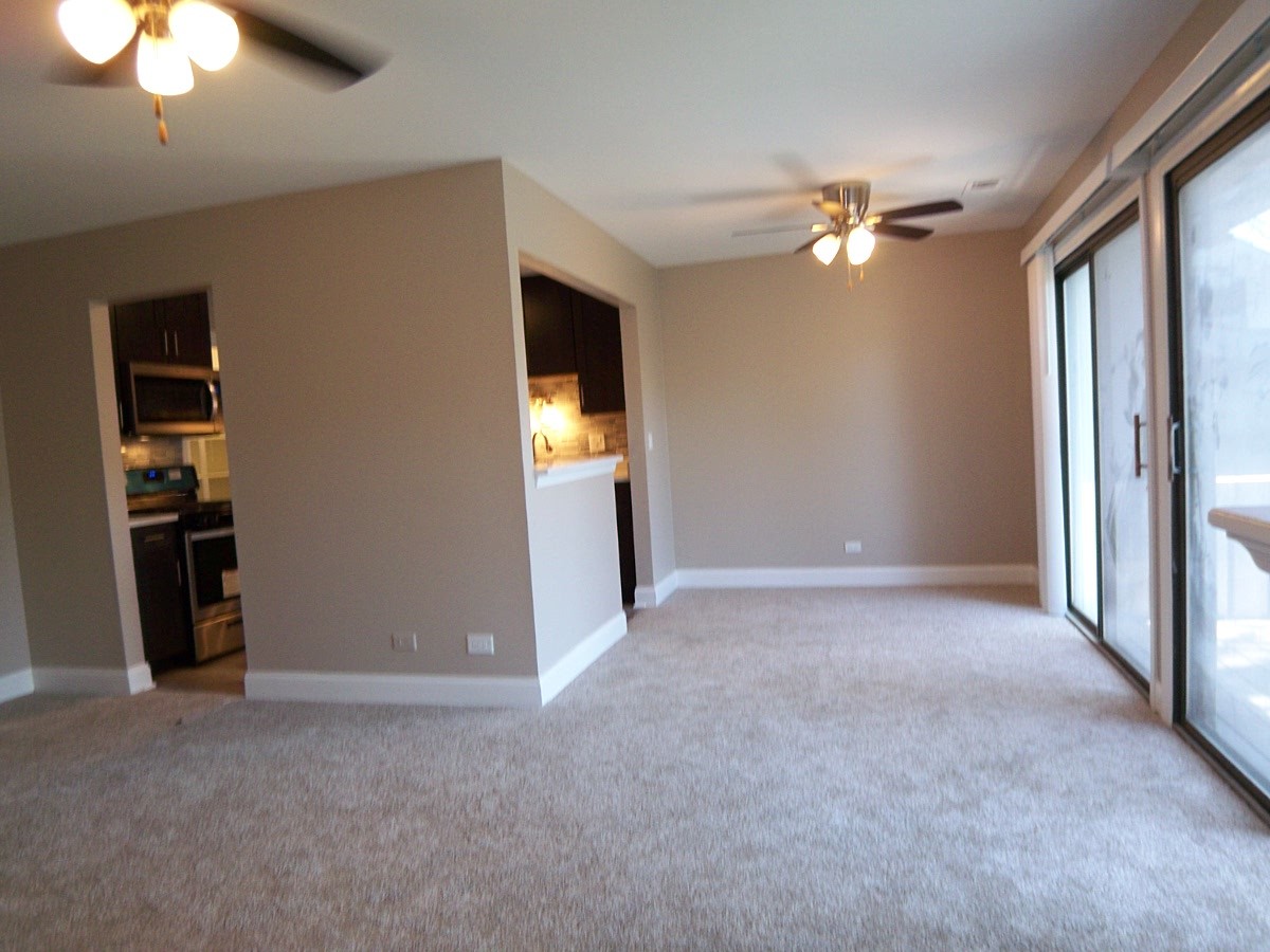 1517 7 Pines Road, Unit C2 Schaumburg, IL 60193 - Photo 8 of 34 a view of empty room with a ceiling fan and window