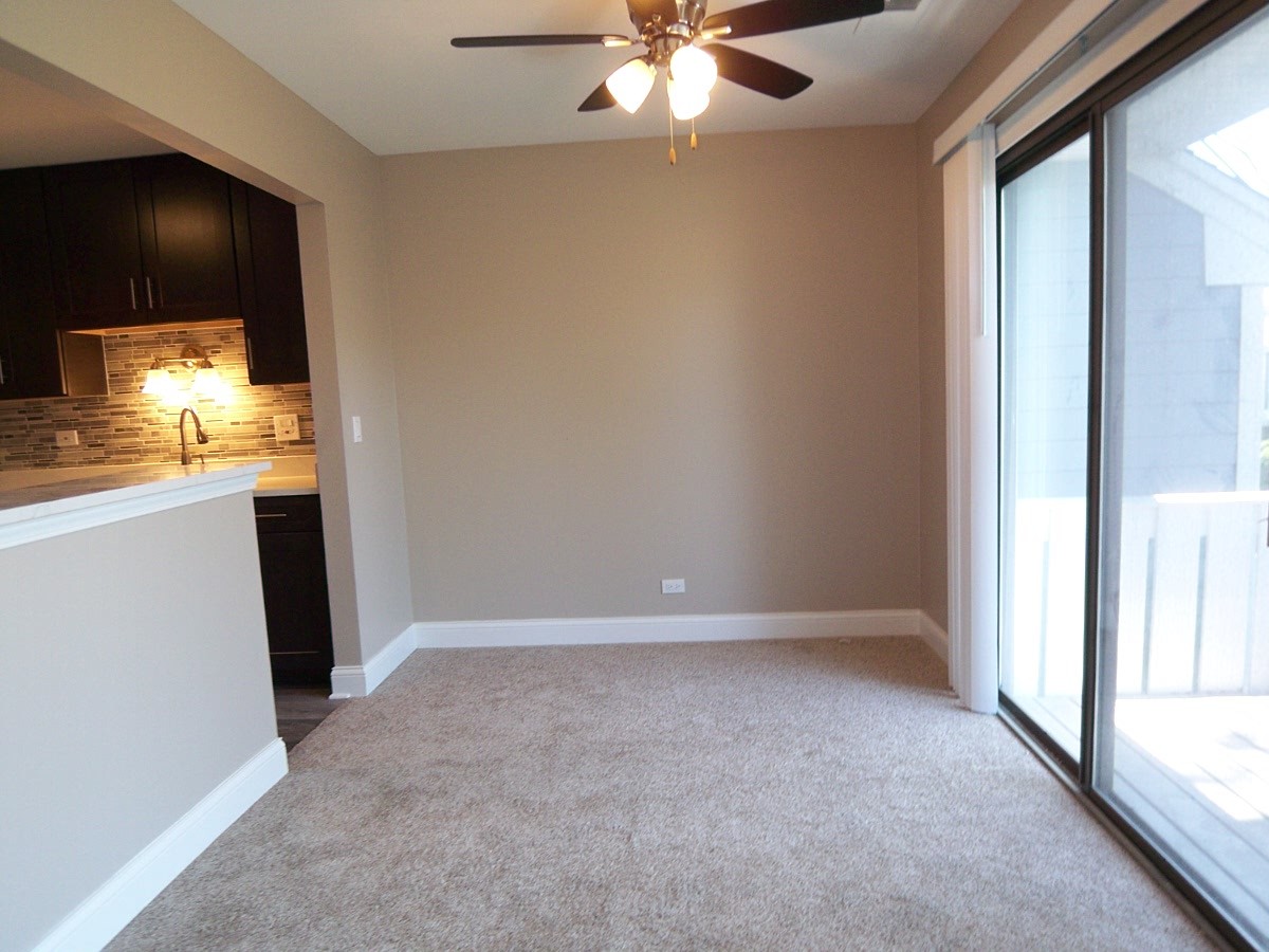 1517 7 Pines Road, Unit C2 Schaumburg, IL 60193 - Photo 10 of 34 an empty room with windows and fan