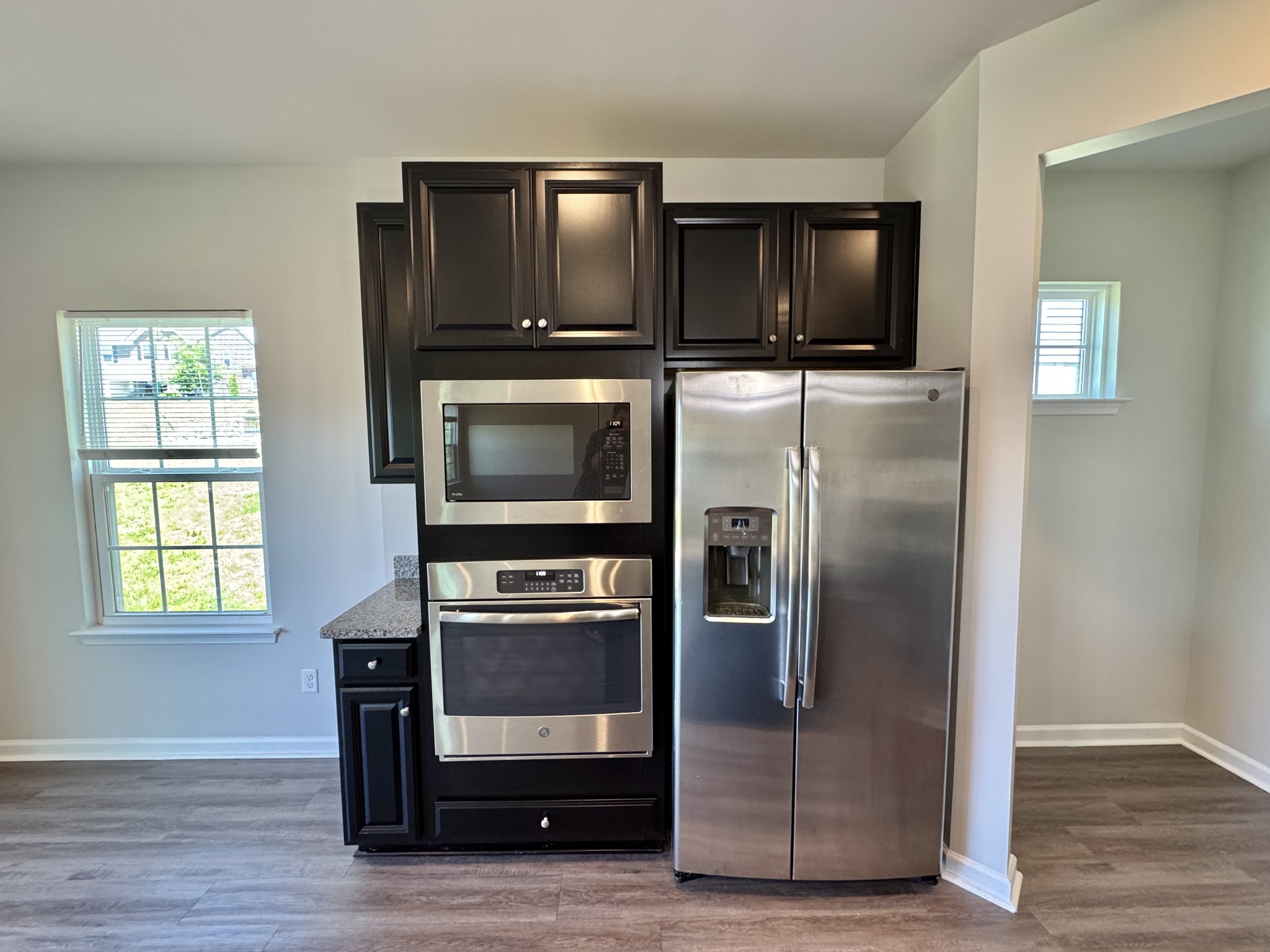 3209 Garrett Lane Columbia, TN 38401 - Photo 11 of 30 a kitchen with granite countertop a refrigerator stove and microwave