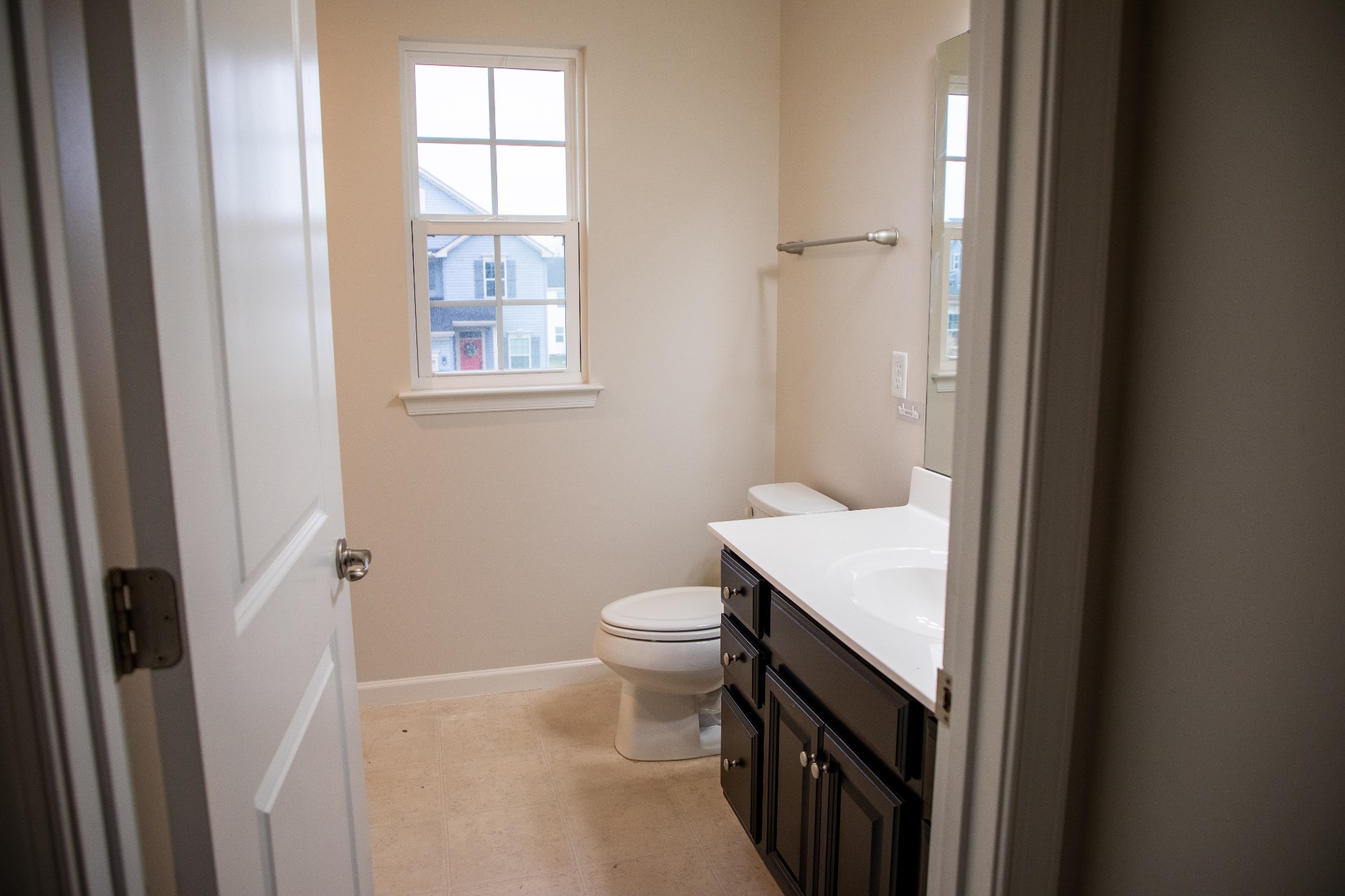 3209 Garrett Lane Columbia, TN 38401 - Photo 22 of 30 a bathroom with a toilet a sink a vanity and a window