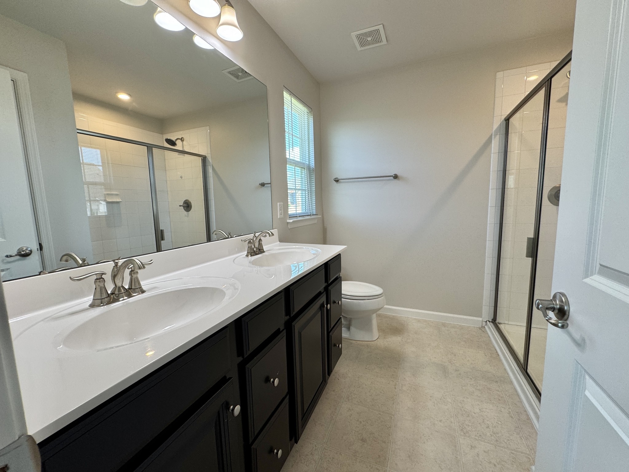 3209 Garrett Lane Columbia, TN 38401 - Photo 23 of 30 a bathroom with a double vanity sink toilet and a mirror