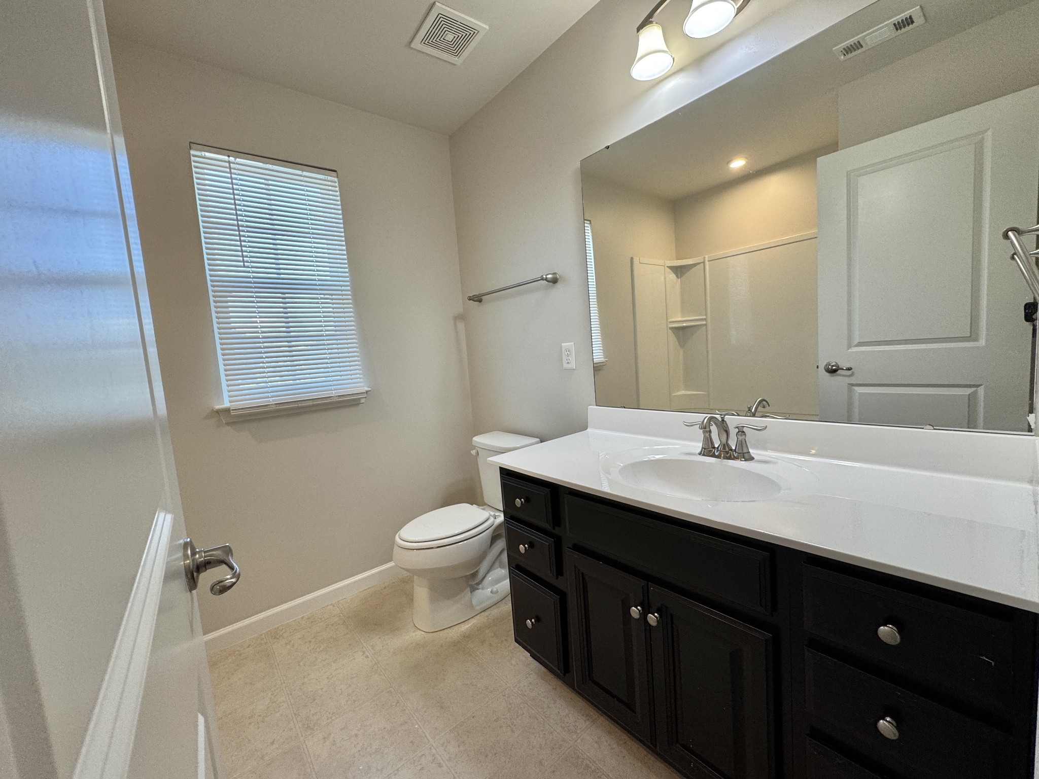 3209 Garrett Lane Columbia, TN 38401 - Photo 24 of 30 a bathroom with a double vanity sink toilet and mirror