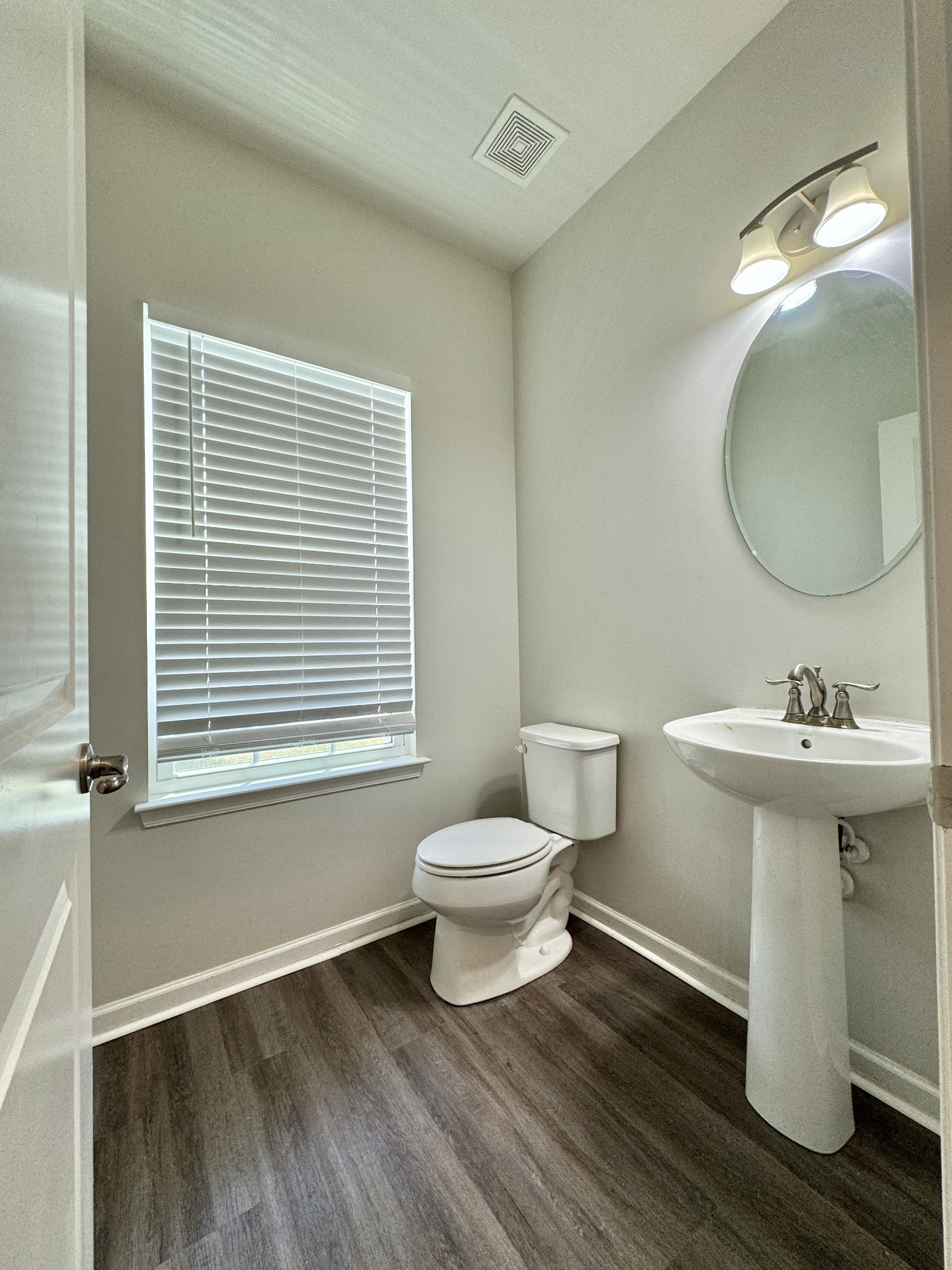 3209 Garrett Lane Columbia, TN 38401 - Photo 4 of 30 a bathroom with a toilet a sink and mirror
