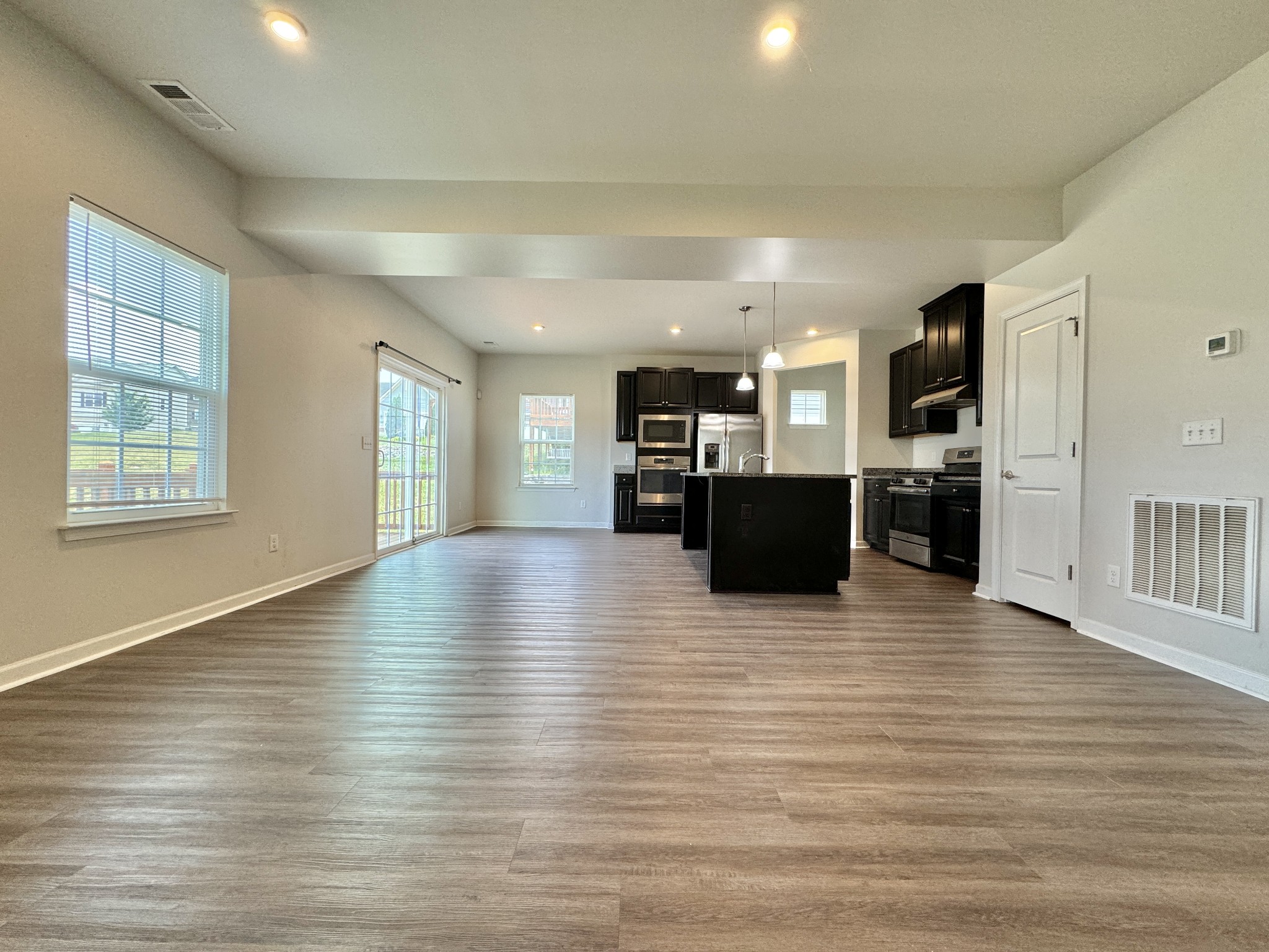 3209 Garrett Lane Columbia, TN 38401 - Photo 6 of 30 a view of a living room with kitchen and flat screen tv