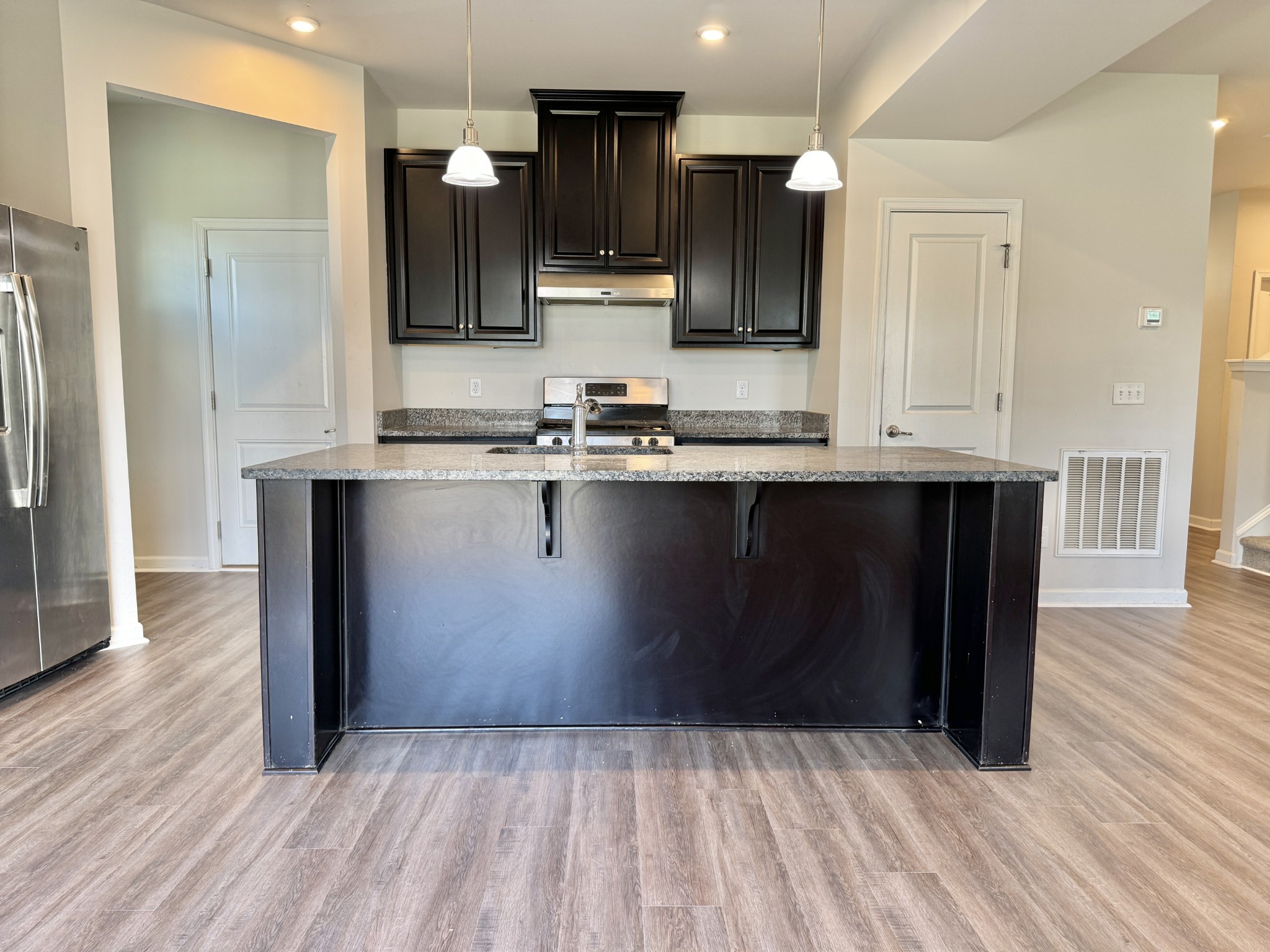 3209 Garrett Lane Columbia, TN 38401 - Photo 8 of 30 a kitchen with stainless steel appliances granite countertop a stove a sink and a microwave