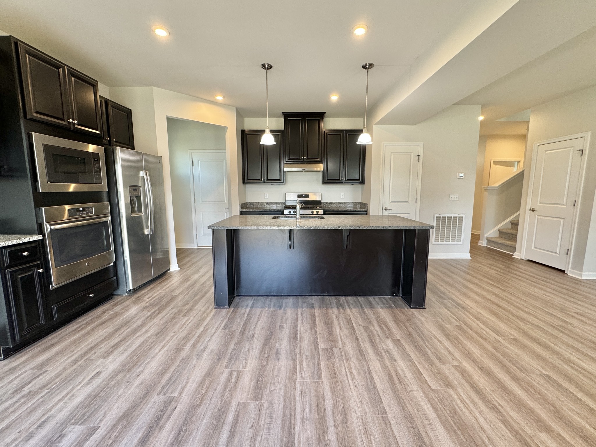 3209 Garrett Lane Columbia, TN 38401 - Photo 9 of 30 a kitchen with stainless steel appliances a refrigerator and a wooden floor