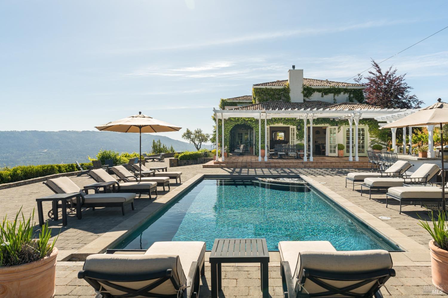a view of a house with swimming pool and sitting area