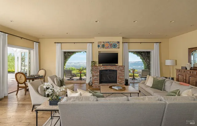 a living room with furniture a large window and a flat screen tv