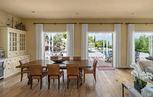 a view of a dining room with furniture and windows