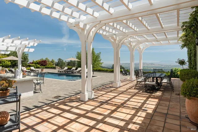 a view of a swimming pool with outdoor seating