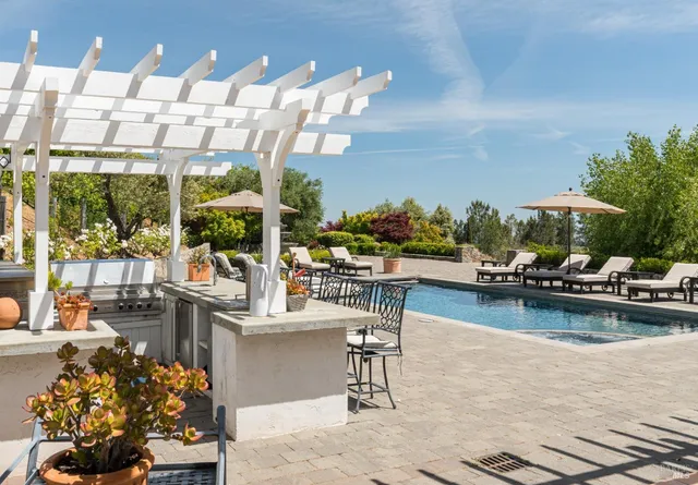 a view of a swimming pool with outdoor seating