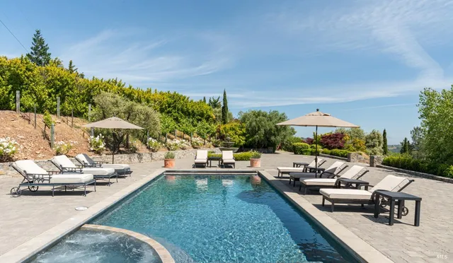 swimming pool view with a seating space