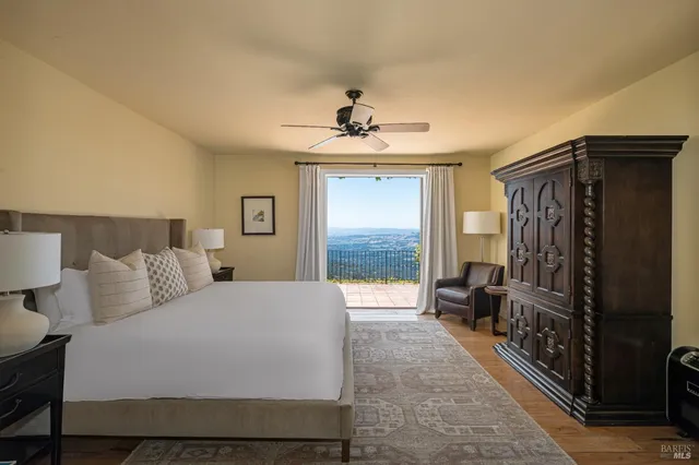 a spacious bedroom with a bed and a chandelier