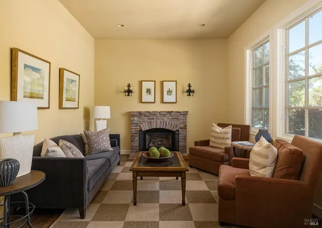a living room with furniture a rug and a fireplace