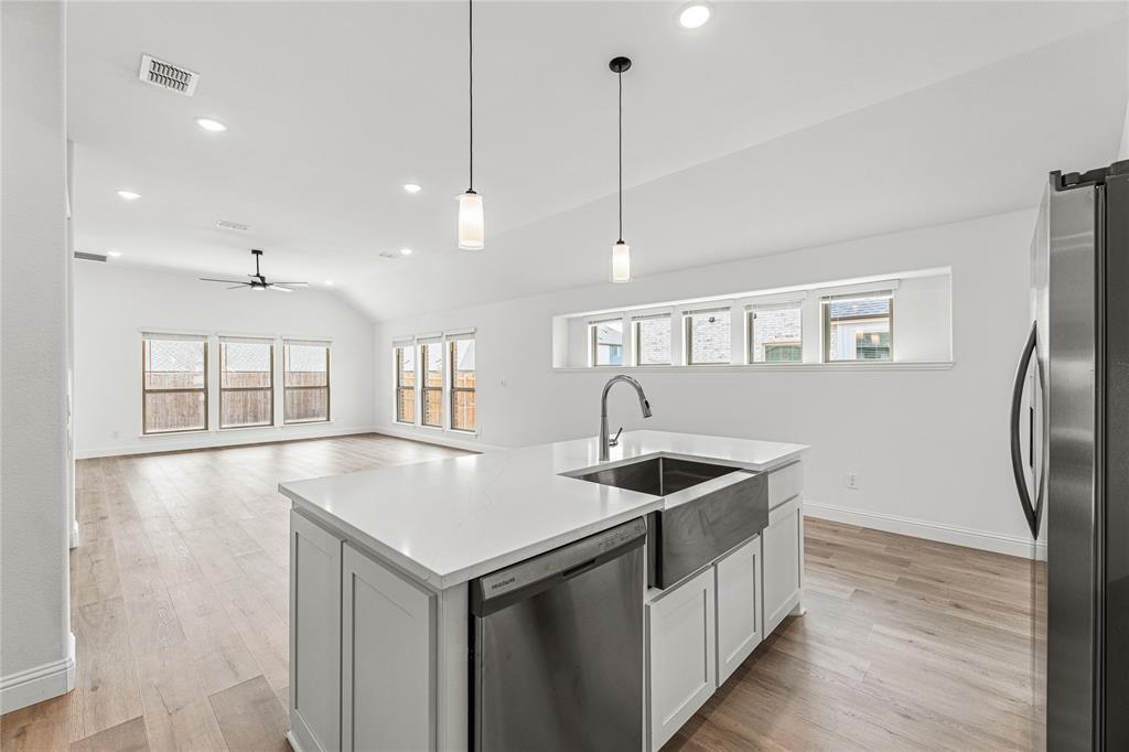 901 Split Oak Lane Anna, TX 75409 - Photo 12 of 31 a kitchen that has a sink stainless steel appliances a counter space and a window