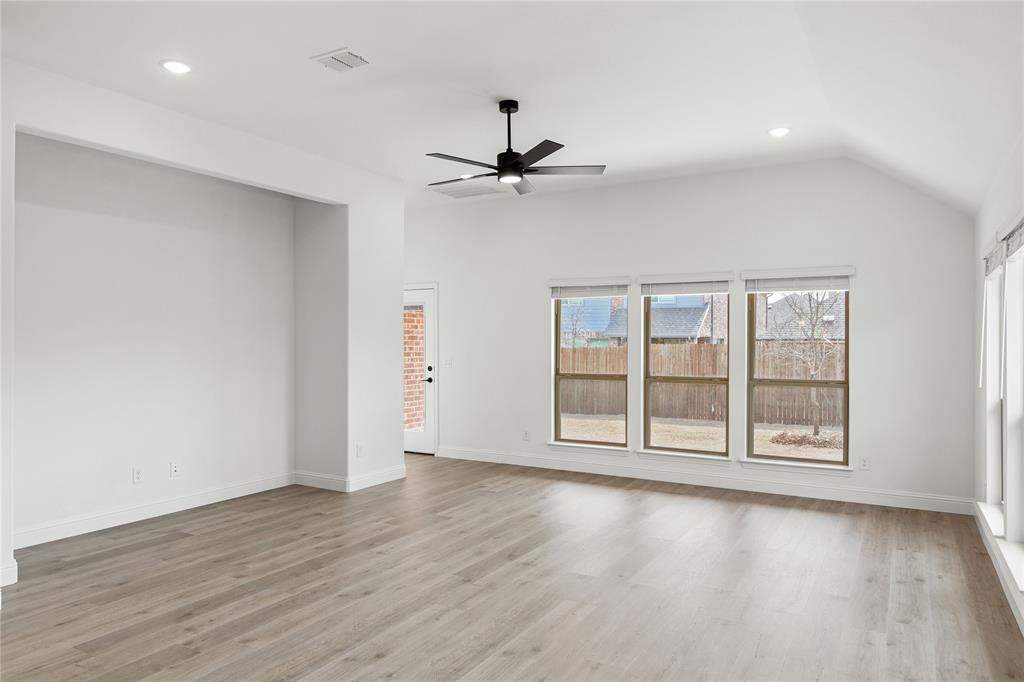 901 Split Oak Lane Anna, TX 75409 - Photo 15 of 31 a view of an empty room with a window and wooden floor
