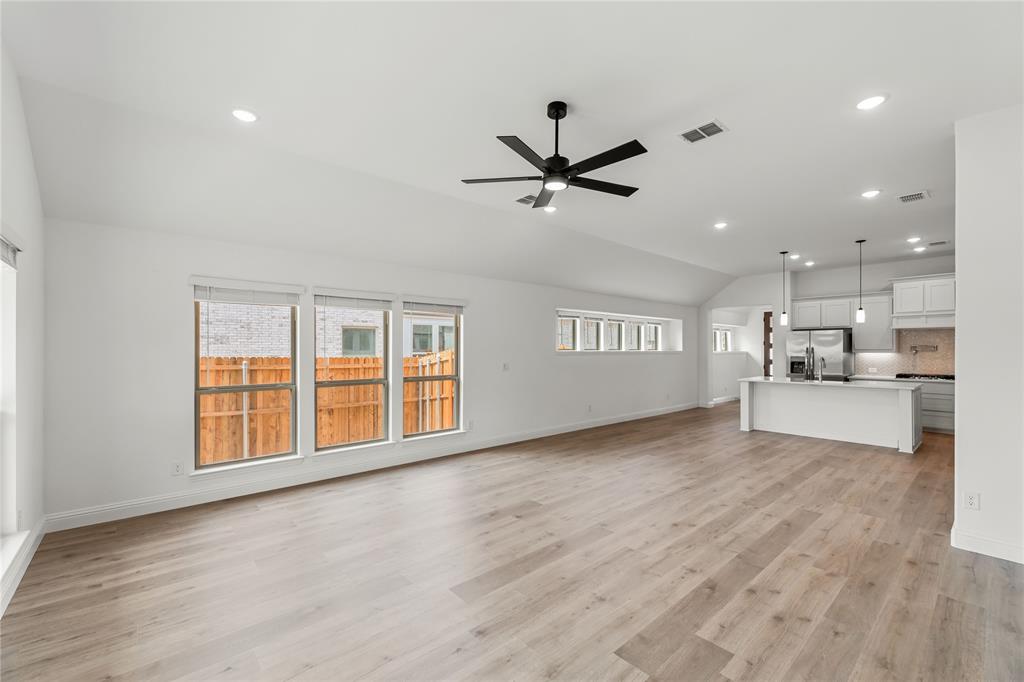 901 Split Oak Lane Anna, TX 75409 - Photo 17 of 31 a view of an empty room with a window and wooden floor