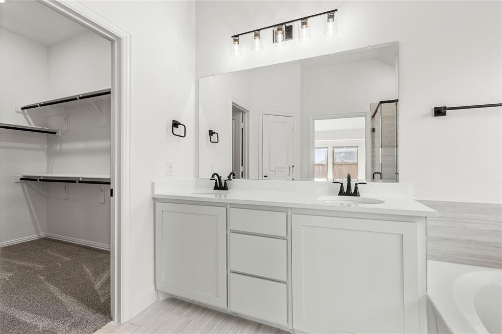 901 Split Oak Lane Anna, TX 75409 - Photo 22 of 31 a bathroom with a sink and a mirror