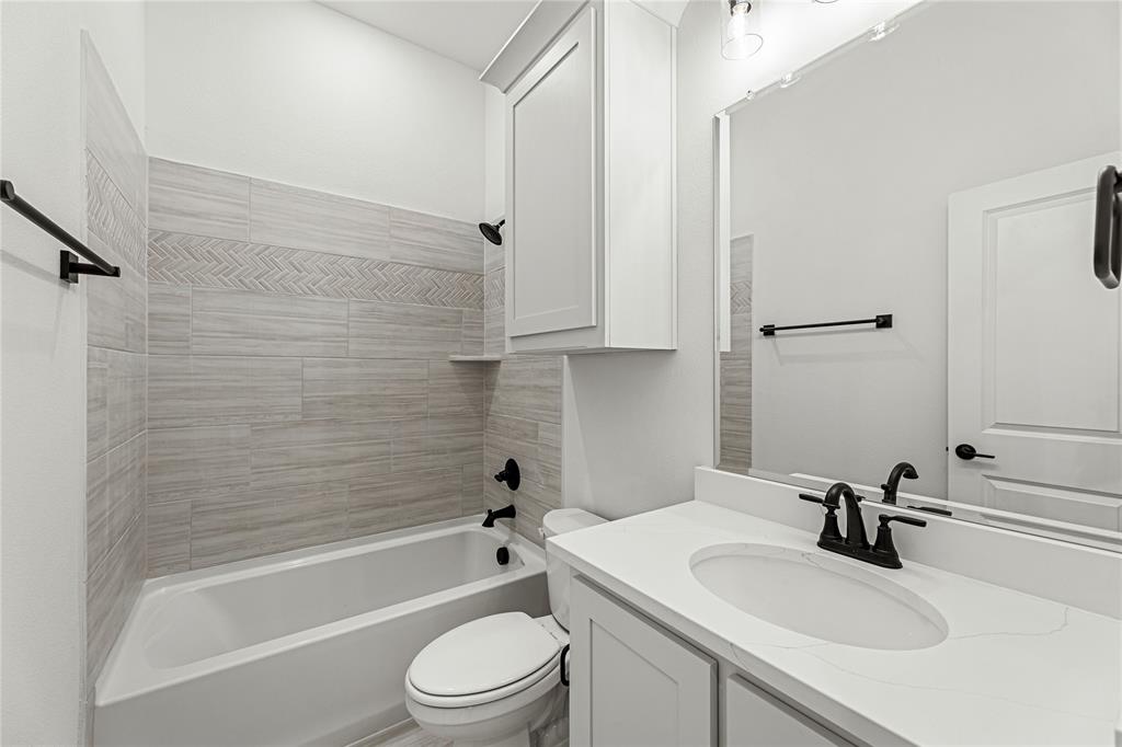 901 Split Oak Lane Anna, TX 75409 - Photo 25 of 31 a bathroom with a sink toilet a bathtub and shower