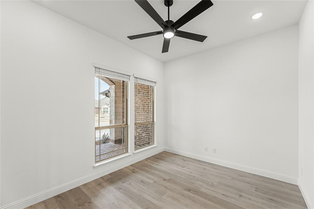901 Split Oak Lane Anna, TX 75409 - Photo 6 of 31 an empty room with wooden floor and windows