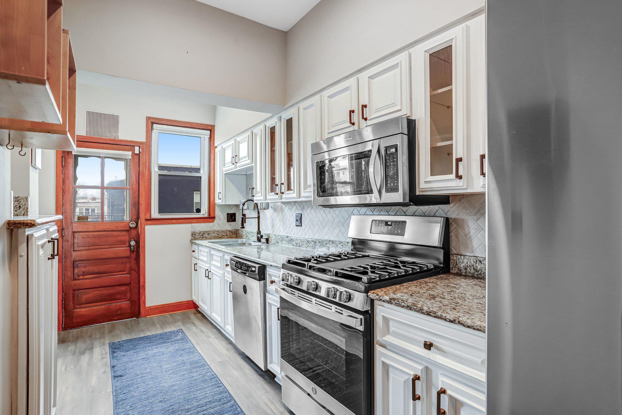 114 Madison Street Northwest Washington, DC 20011 - Photo 22 of 80 a kitchen with stainless steel appliances granite countertop a stove and a refrigerator