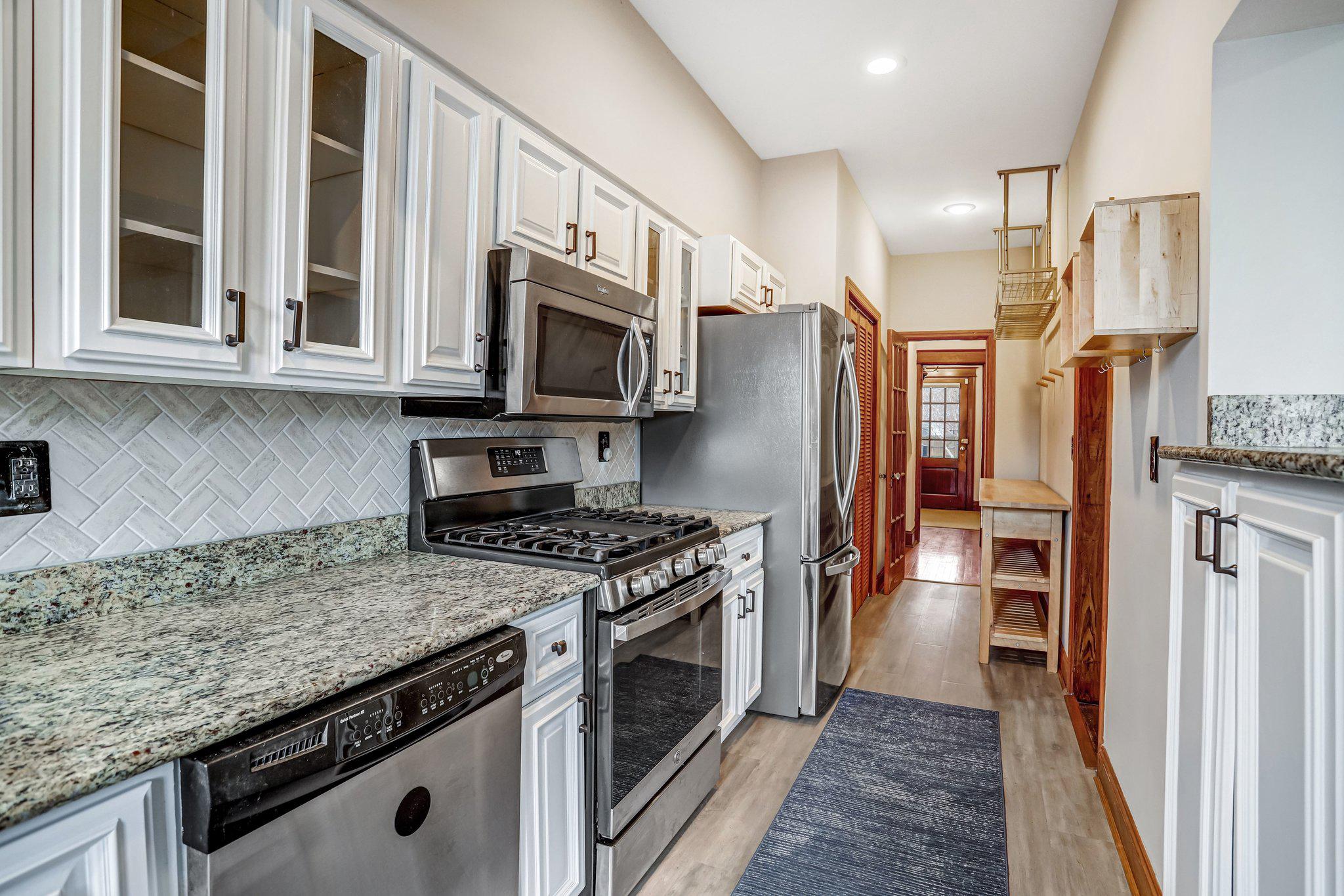 114 Madison Street Northwest Washington, DC 20011 - Photo 26 of 80 a kitchen with stainless steel appliances granite countertop a stove top oven a refrigerator and a sink