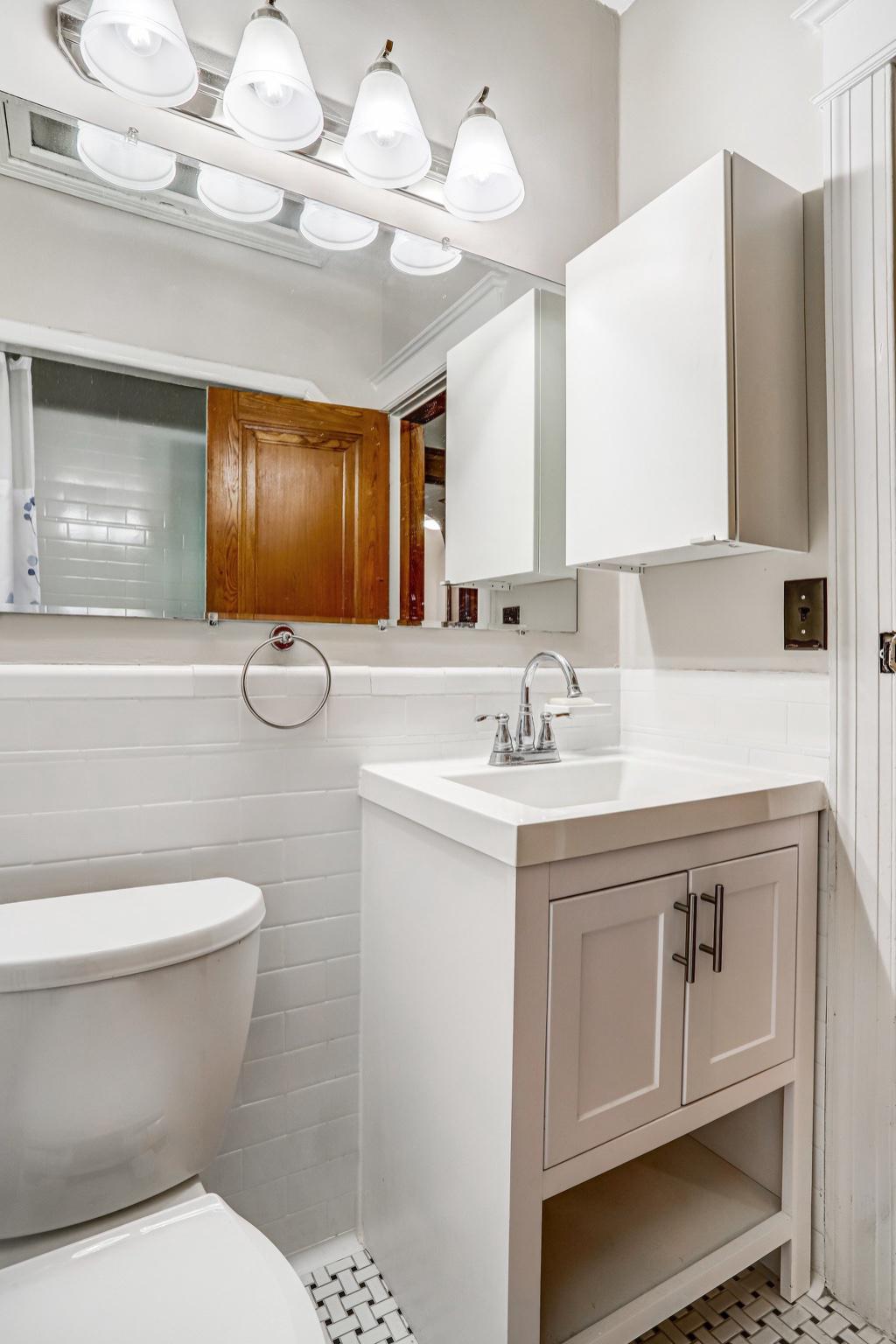114 Madison Street Northwest Washington, DC 20011 - Photo 52 of 80 a bathroom with a sink a toilet and a mirror