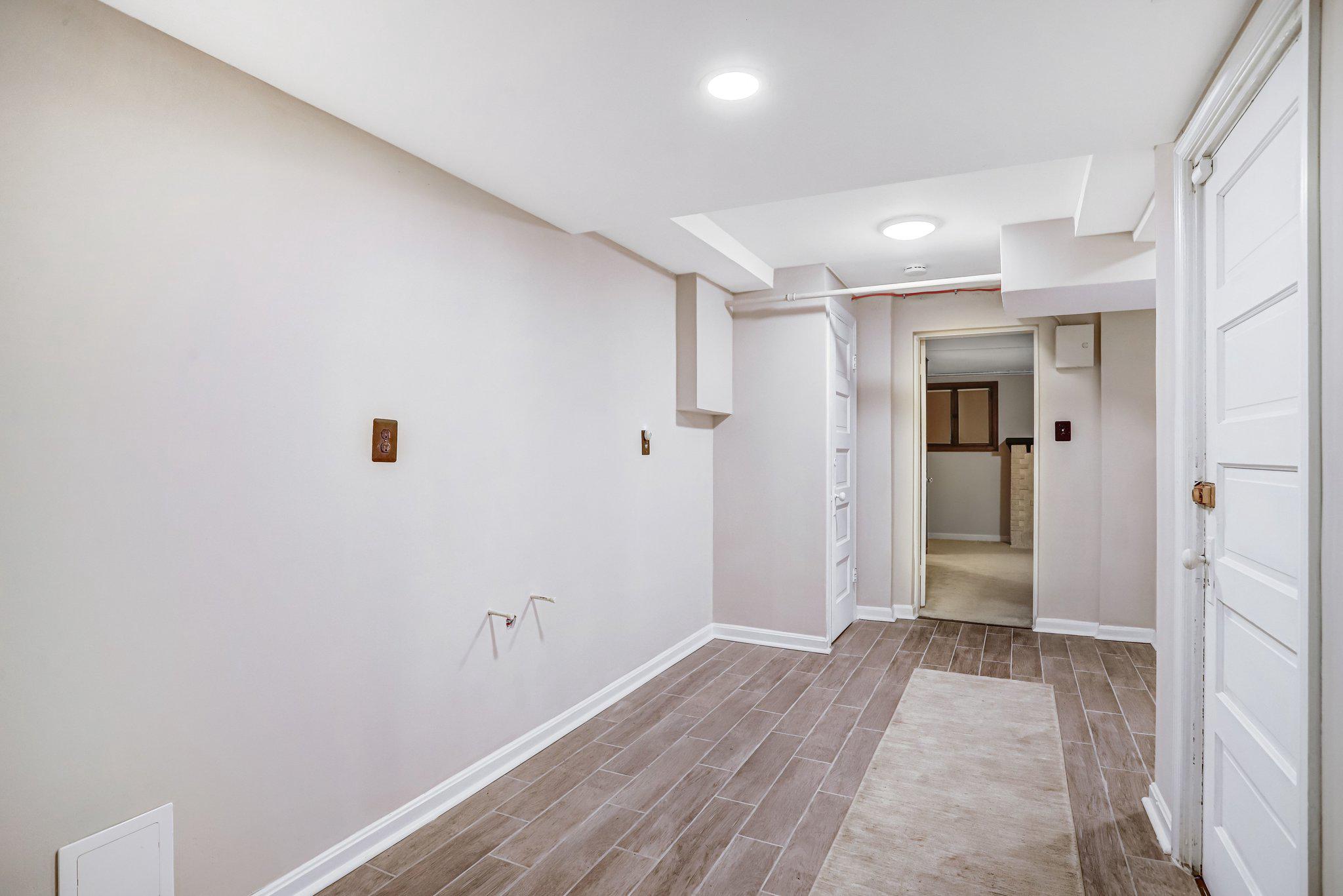 114 Madison Street Northwest Washington, DC 20011 - Photo 61 of 80 a view of a hallway with wooden floor and a bathroom