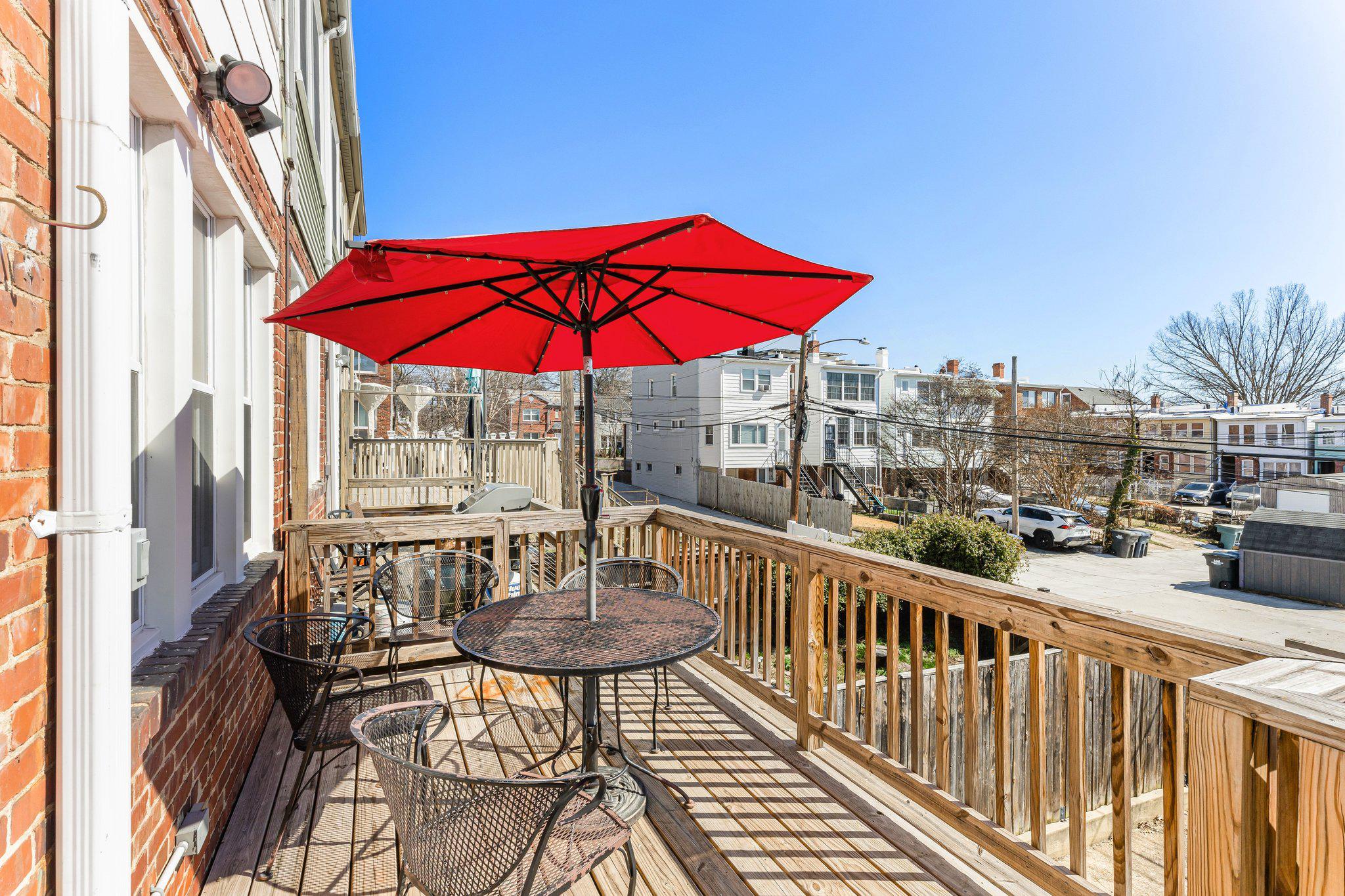 114 Madison Street Northwest Washington, DC 20011 - Photo 66 of 80 a view of balcony with furniture and umbrella