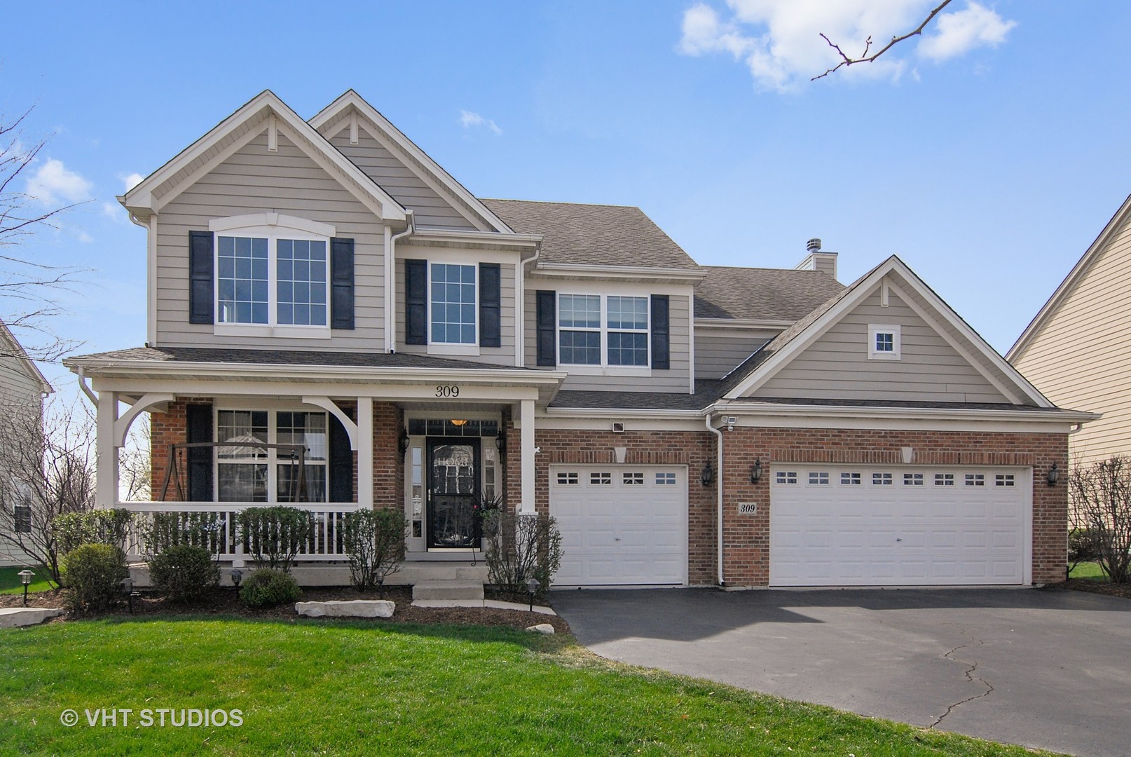 309 Monument Road Elgin, IL 60124 - Photo 1 of 25 a front view of a house with a yard and garage