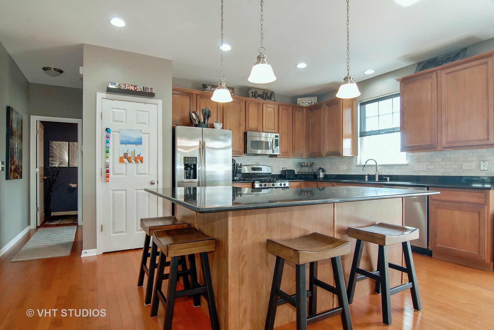 309 Monument Road Elgin, IL 60124 - Photo 6 of 25 a kitchen with stainless steel appliances granite countertop counter space a sink and a refrigerator