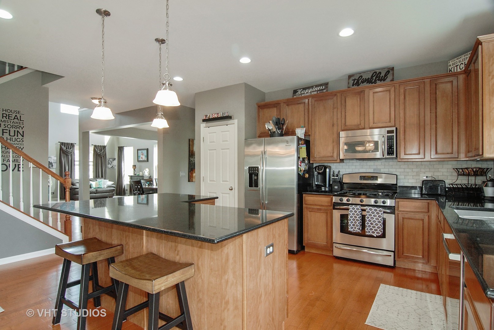 309 Monument Road Elgin, IL 60124 - Photo 7 of 25 a kitchen with stainless steel appliances granite countertop a stove top oven a refrigerator a sink and a granite counter tops