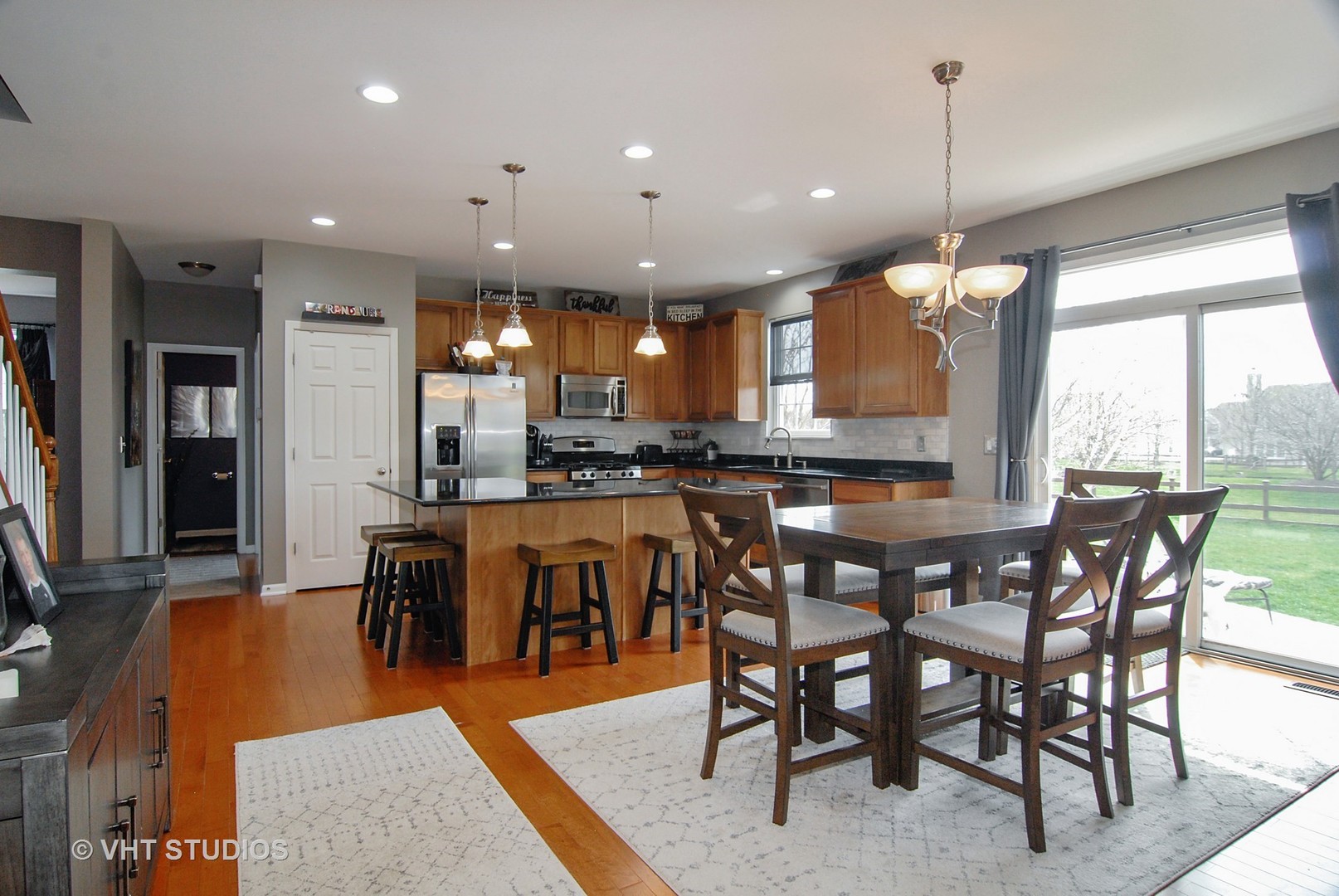 309 Monument Road Elgin, IL 60124 - Photo 8 of 25 a view of a dining area with furniture window and wooden floor