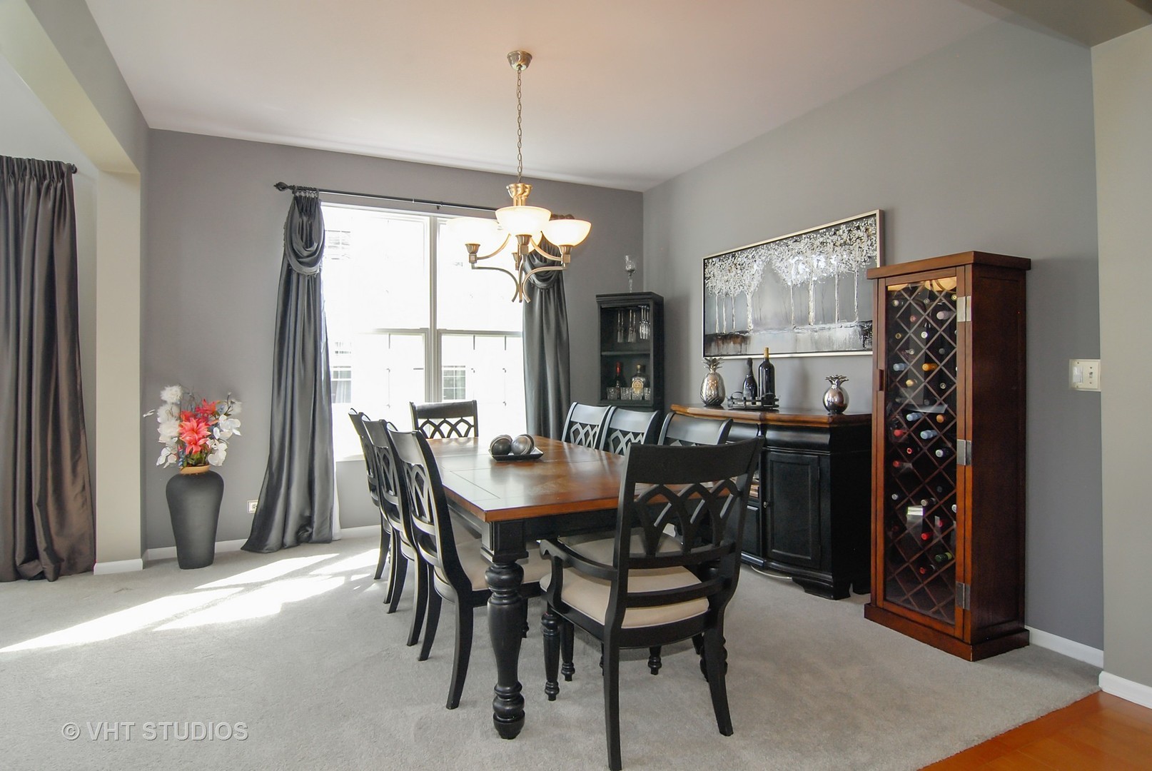 309 Monument Road Elgin, IL 60124 - Photo 9 of 25 a view of a dining room and livingroom with furniture window and wooden floor