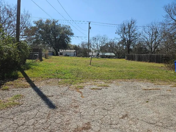 a view of a field with a fence