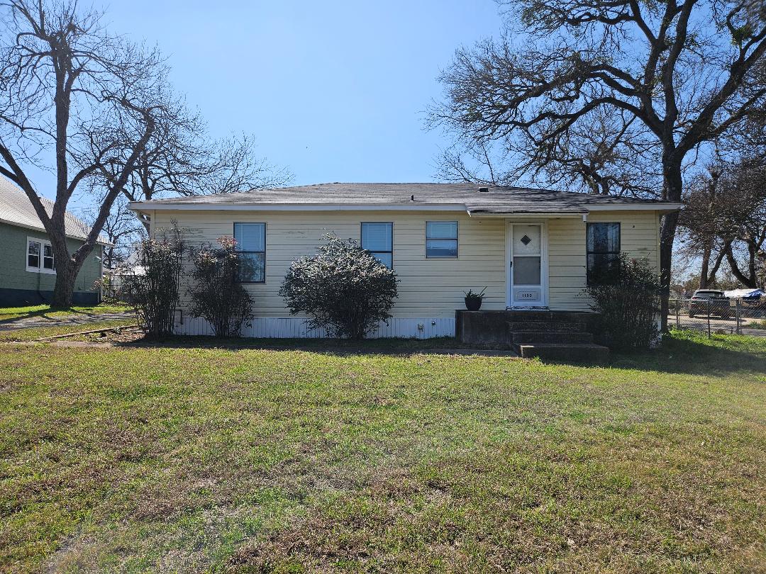 1130 North Main Street Elgin, TX 78621 - Photo 2 of 16 front view of a house with a yard
