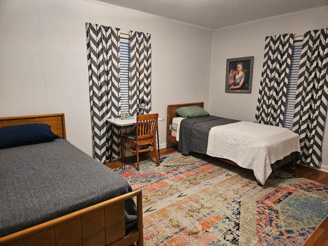 1130 North Main Street Elgin, TX 78621 - Photo 7 of 16 a bedroom with a bed and a window