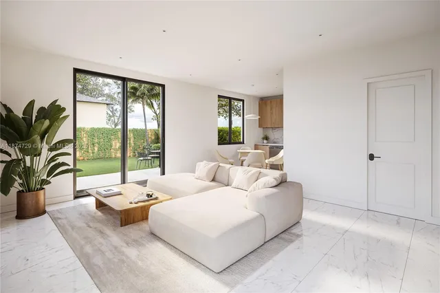 a living room with furniture and large windows