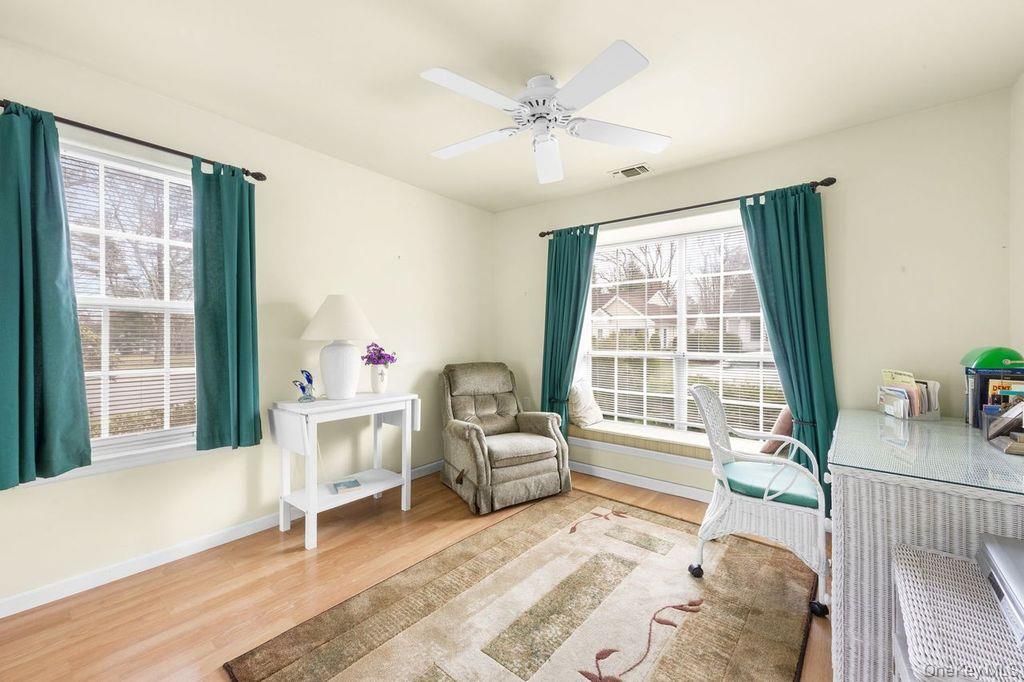 16 Huntington Court Ridge, NY 11961 - Photo 12 of 43 a bedroom with a bed and a large window with outer view