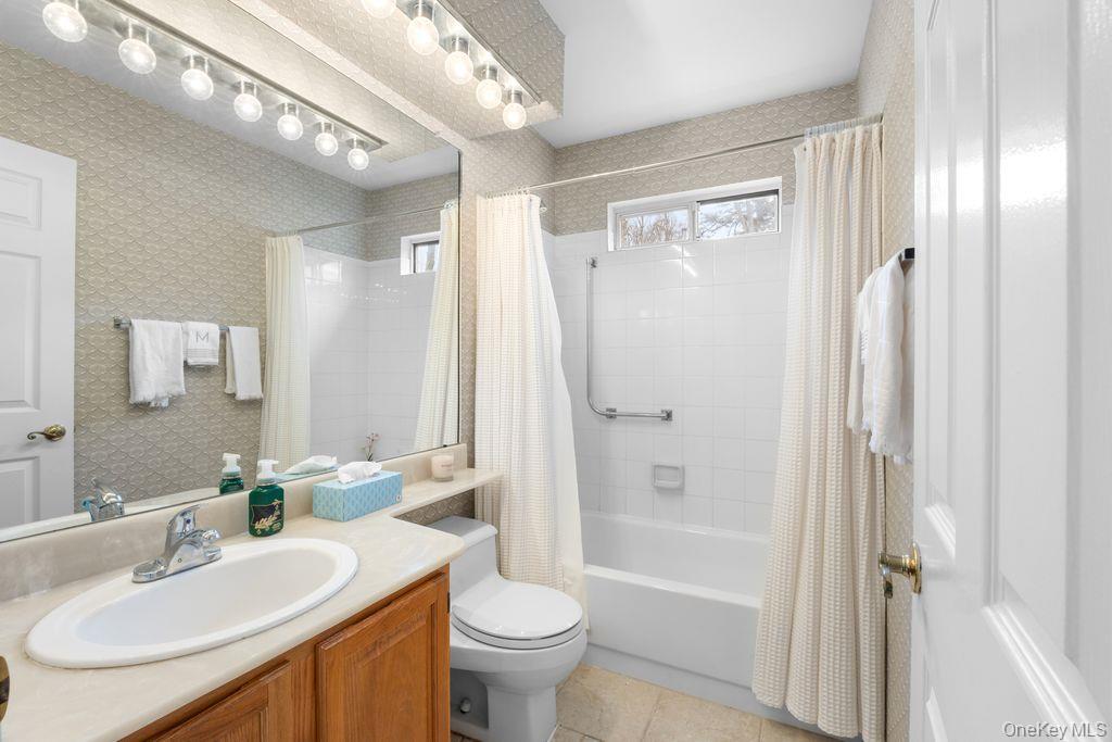 16 Huntington Court Ridge, NY 11961 - Photo 15 of 43 a bathroom with a sink a toilet and shower