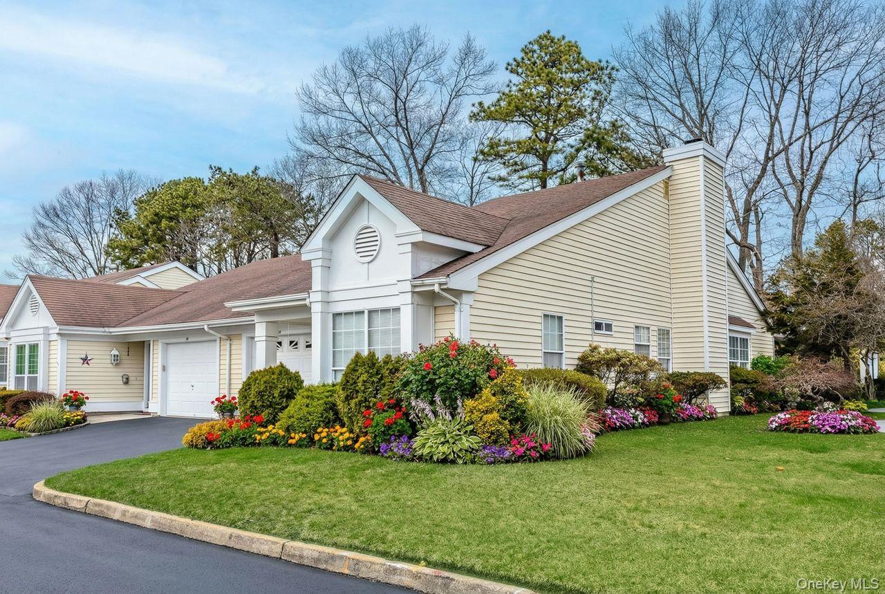 16 Huntington Court Ridge, NY 11961 - Photo 2 of 43 a front view of house with yard and green space