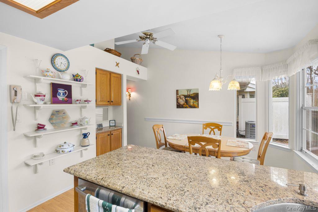 16 Huntington Court Ridge, NY 11961 - Photo 22 of 43 a large kitchen with a table and chairs