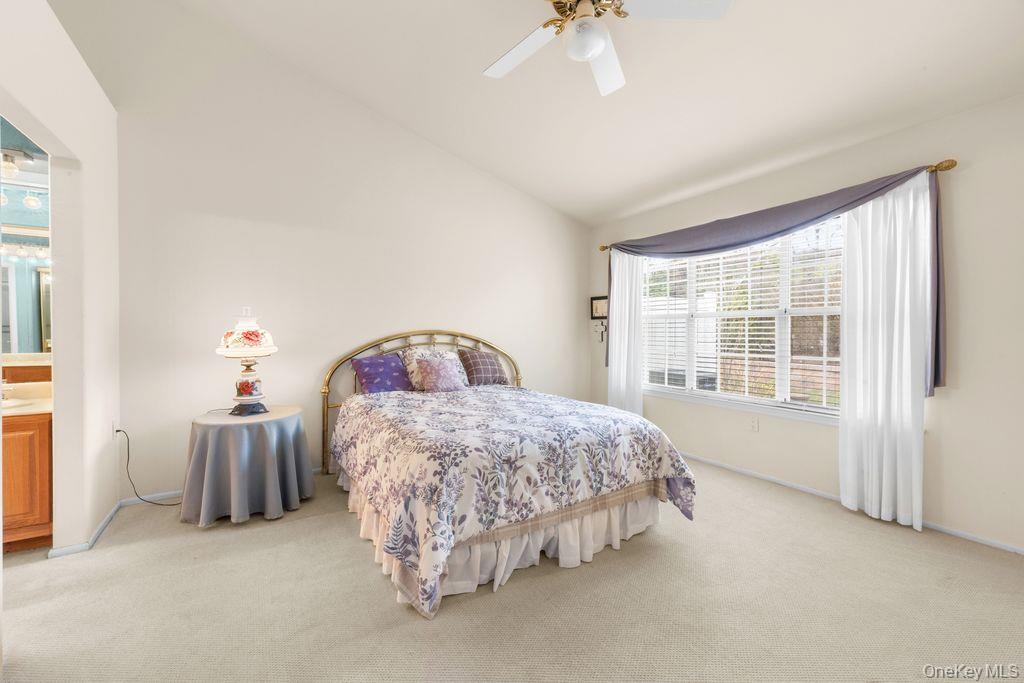 16 Huntington Court Ridge, NY 11961 - Photo 26 of 43 a spacious bedroom with a bed and a window