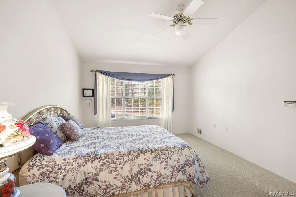 16 Huntington Court Ridge, NY 11961 - Photo 27 of 43 a bedroom with a bed and a window