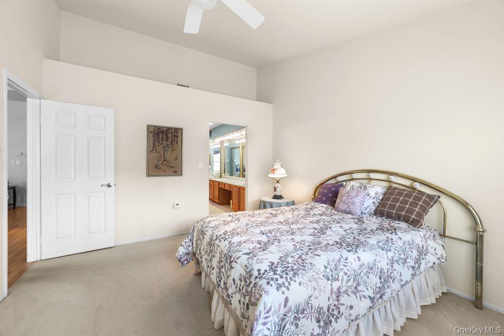 16 Huntington Court Ridge, NY 11961 - Photo 28 of 43 a bedroom with a bed and a table