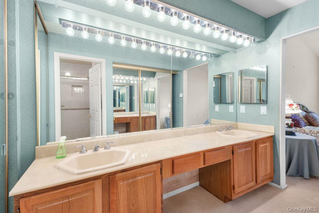 16 Huntington Court Ridge, NY 11961 - Photo 30 of 43 a bathroom with a sink double vanity and a mirror