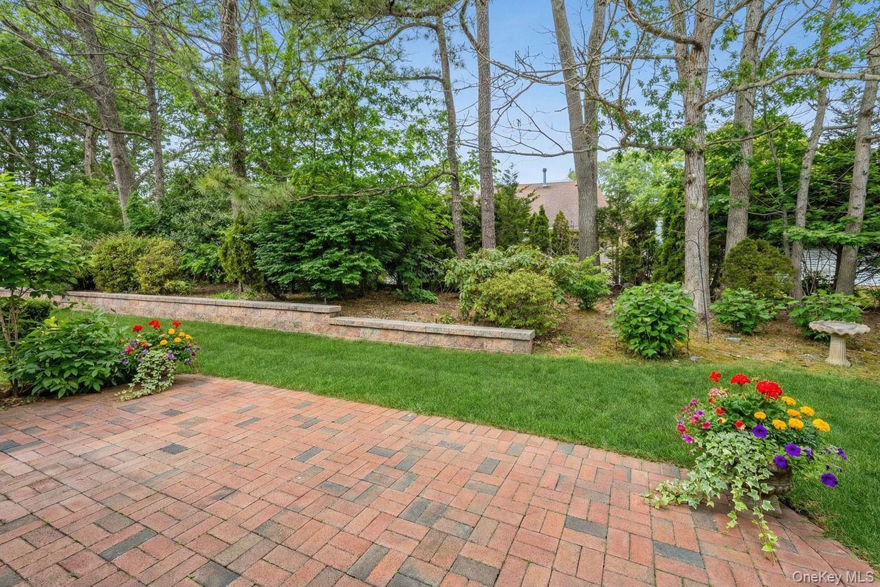 16 Huntington Court Ridge, NY 11961 - Photo 33 of 43 a view of backyard with a garden and plants