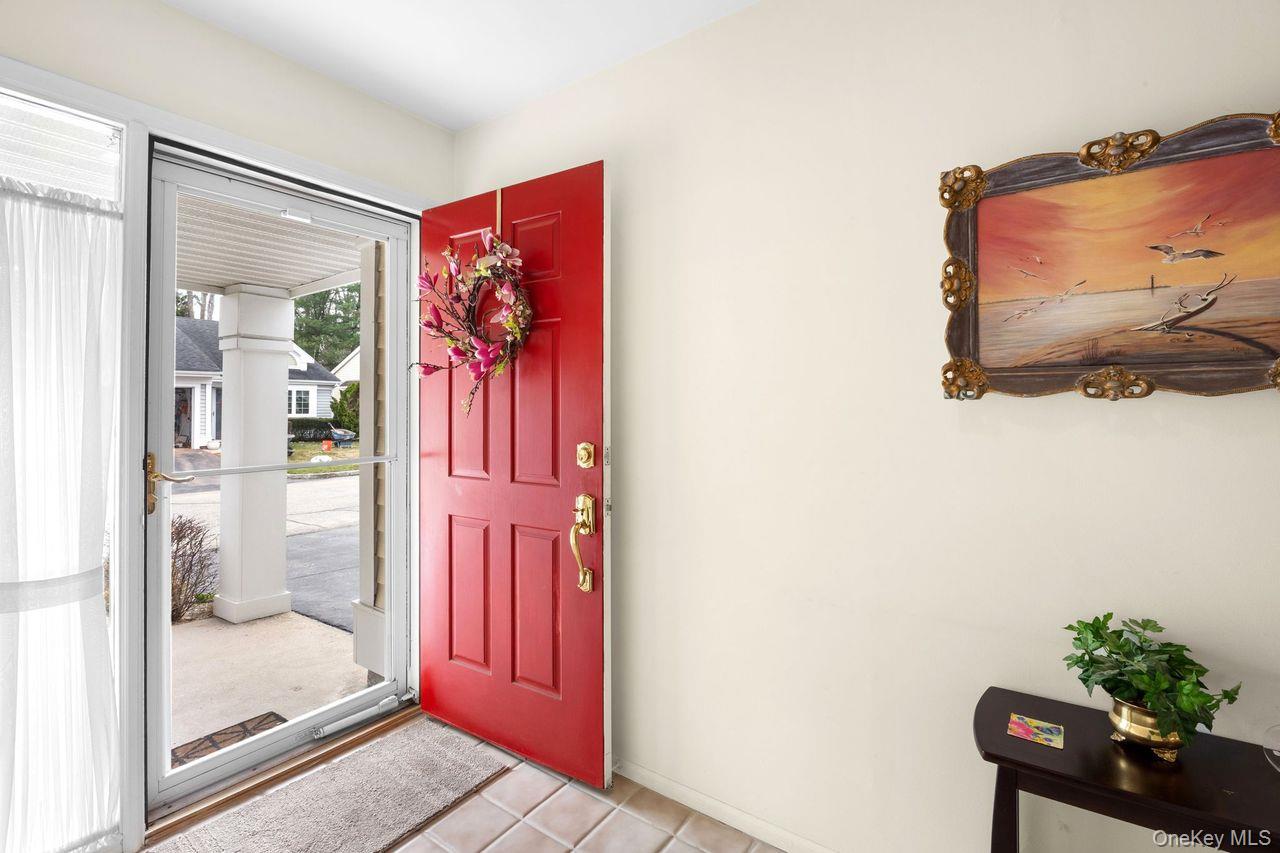 16 Huntington Court Ridge, NY 11961 - Photo 4 of 43 a very nice looking room with a glass door